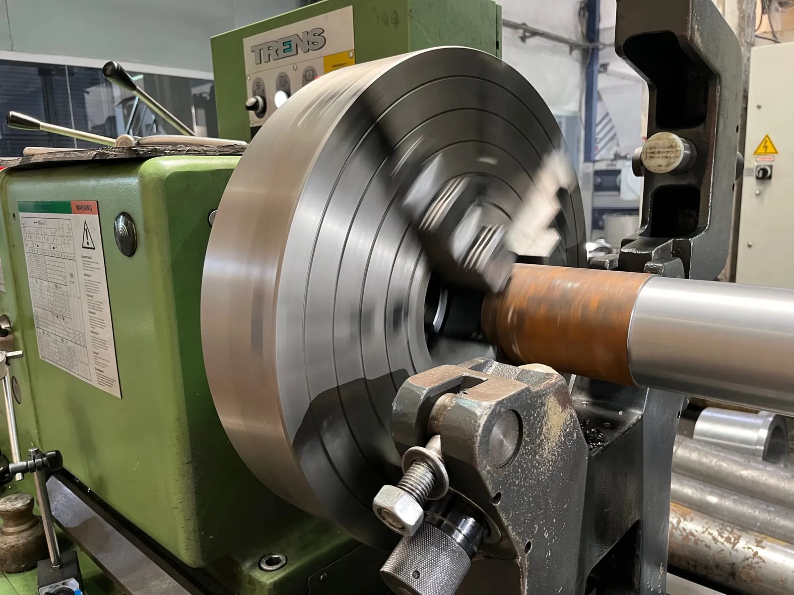Large steel disc turned on lathe faceplate