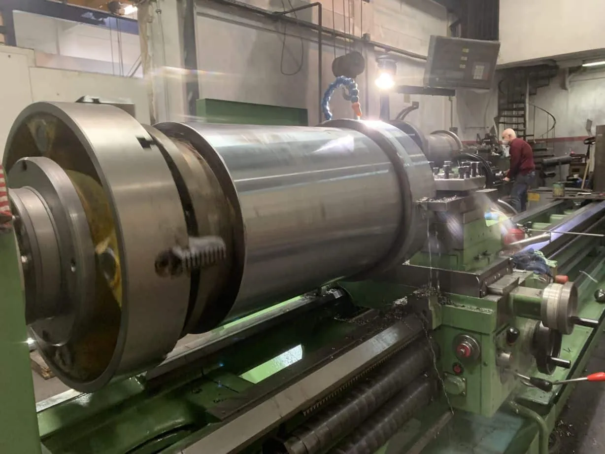 Close-up of heavy steel roller shell during turning