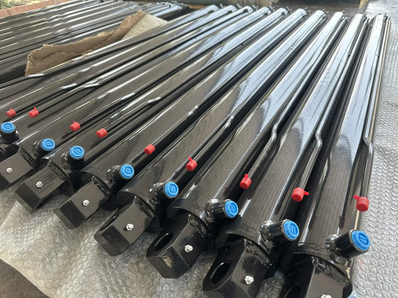Painted hydraulic cylinders with port caps fitted