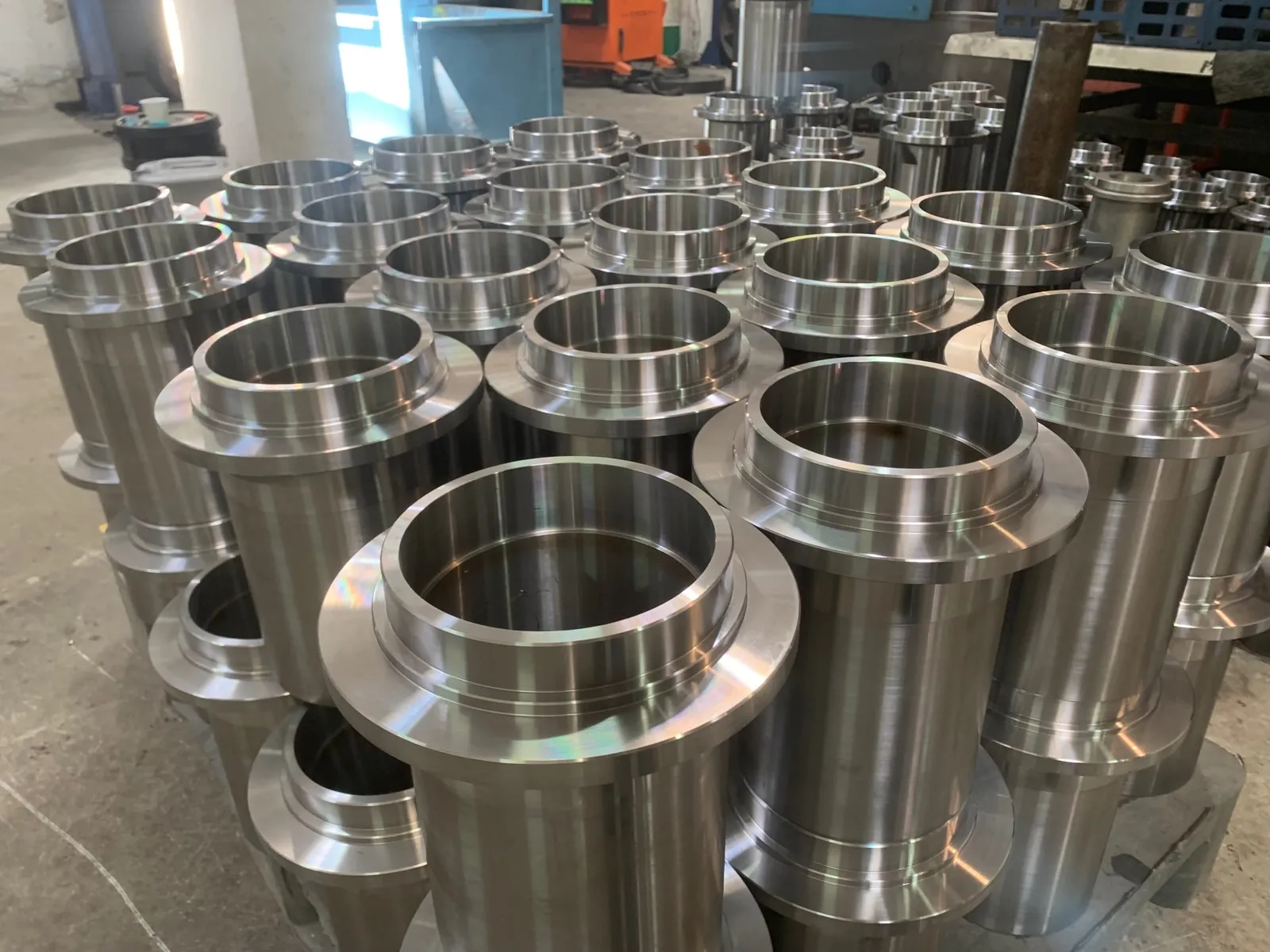 Machined flanged steel sleeves and roller hubs
